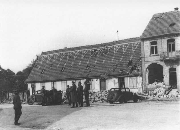 Deutsche Truppen vor dem schwer beschädigten Gasthaus zur fröhlichen Pfalz